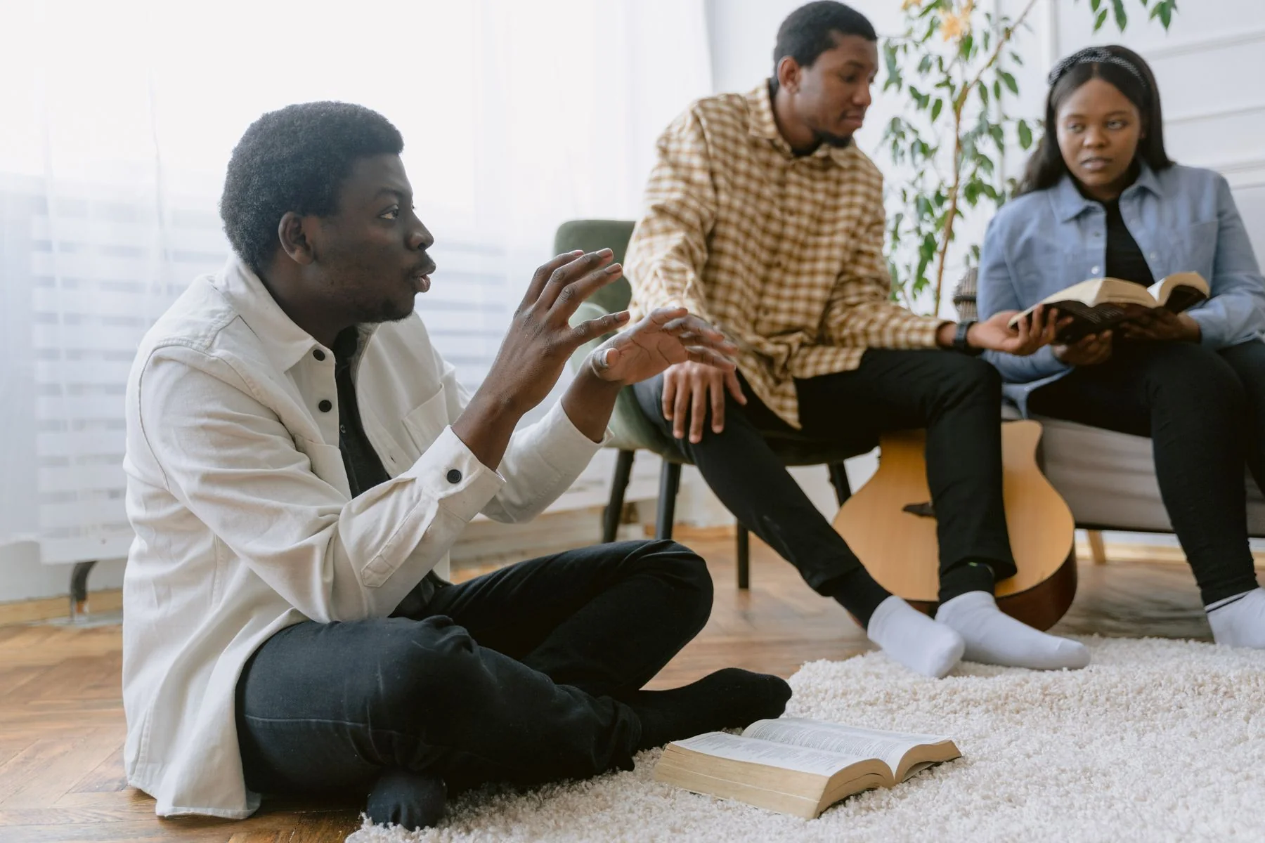 Black adults studying the Bible together